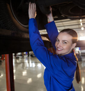 Female Mechanic Servicing A Car